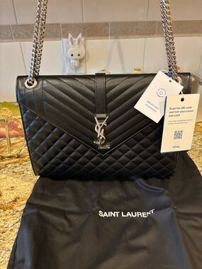 Saint Laurent Black Quilted Leather Shoulder Bag with Silver YSL Hardware.